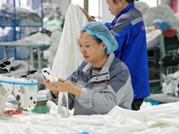 A worker makes bedding at a workshop of Wadfeng Automotive Supplies (Nantong) Co., Ltd. in Duntou town, Haian city, East China's Jiangsu pro...