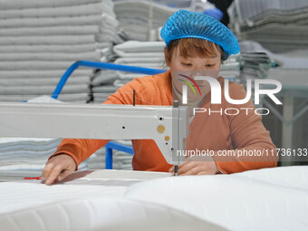 A worker makes bedding at a workshop of Wadfeng Automotive Supplies (Nantong) Co., Ltd. in Duntou town, Haian city, East China's Jiangsu pro...