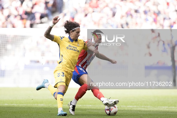 In Madrid, Spain, on November 3, Lenglet of Atletico de Madrid and Fabio Silva of Las Palmas fight for the ball during the La Liga 2024/25 m...