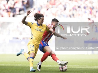 In Madrid, Spain, on November 3, Lenglet of Atletico de Madrid and Fabio Silva of Las Palmas fight for the ball during the La Liga 2024/25 m...