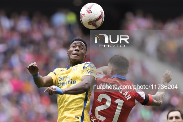 Javi Galan of Atletico de Madrid and Dario Essugo of Las Palmas fight for the ball during the La Liga 2024/25 match between Atletico de Madr...