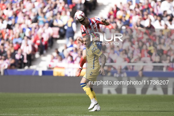 Javi Galan of Atletico de Madrid and Sandro Ramirez of Las Palmas fight for the ball during the La Liga 2024/25 match between Atletico de Ma...