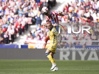 Javi Galan of Atletico de Madrid and Sandro Ramirez of Las Palmas fight for the ball during the La Liga 2024/25 match between Atletico de Ma...