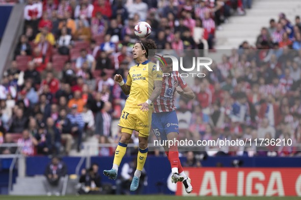 In Madrid, Spain, on November 3, Lenglet of Atletico de Madrid and Fabio Silva of Las Palmas fight for the ball during the La Liga 2024/25 m...