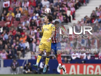 In Madrid, Spain, on November 3, Lenglet of Atletico de Madrid and Fabio Silva of Las Palmas fight for the ball during the La Liga 2024/25 m...