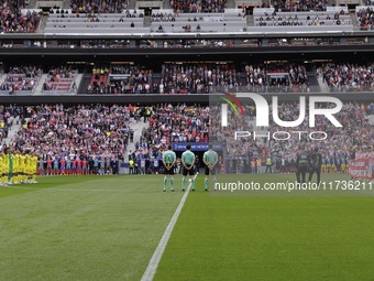 In Madrid, Spain, on November 3, players from Atletico de Madrid and Las Palmas show respect for the victims of the Valencia rains during th...