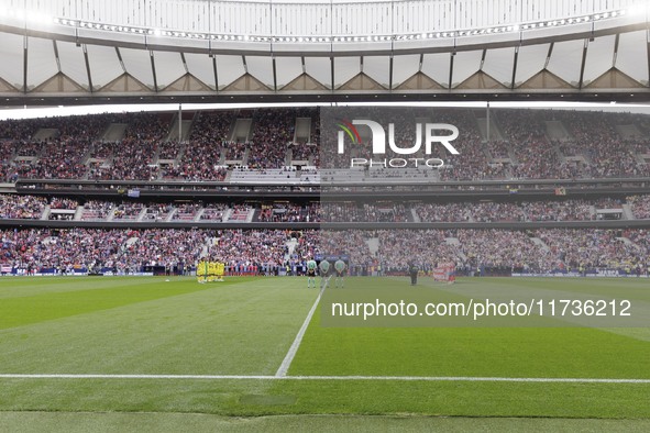 In Madrid, Spain, on November 3, players from Atletico de Madrid and Las Palmas show respect for the victims of the Valencia rains during th...