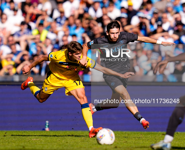 Khvicha Kvaratskhelia of SSC Napoli and Charles De Ketelaere of Atalanta BC compete for the ball during the serie Serie A Enilive match betw...