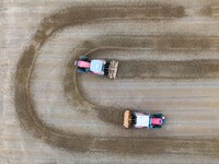 Workers operate large equipment at the construction site of the second phase of the Huaihe River Inlet Waterway project in Qingjiangpu distr...