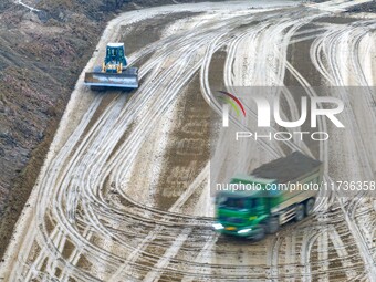 Workers operate large equipment at the construction site of the second phase of the Huaihe River Inlet Waterway project in Qingjiangpu distr...