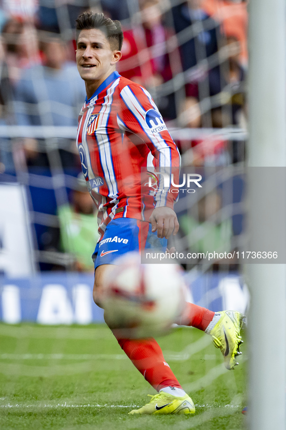 Giuliano Simeone of Atletico de Madrid shows the ball of his goal during the La Liga EA Sports 2024/25 football match between Atletico de Ma...