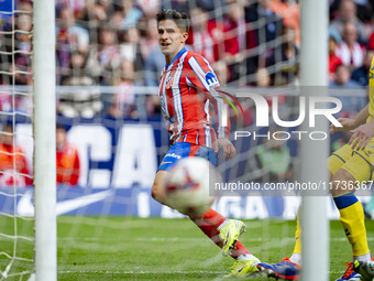 Giuliano Simeone of Atletico de Madrid shows the ball of his goal during the La Liga EA Sports 2024/25 football match between Atletico de Ma...