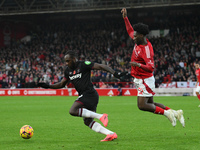 Ola Aina of Nottingham Forest puts pressure on Michail Antonio of West Ham United during the Premier League match between Nottingham Forest...