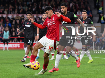 Morgan Gibbs-White of Nottingham Forest competes with Emerson Palmieri of West Ham United during the Premier League match between Nottingham...