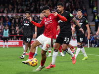 Morgan Gibbs-White of Nottingham Forest competes with Emerson Palmieri of West Ham United during the Premier League match between Nottingham...