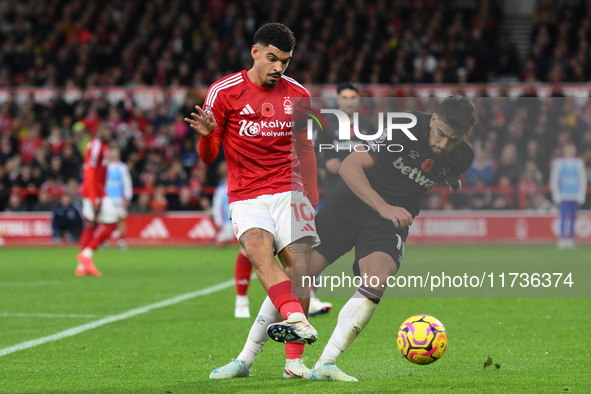 Morgan Gibbs-White of Nottingham Forest battles with Lucas Paqueta of West Ham United during the Premier League match between Nottingham For...