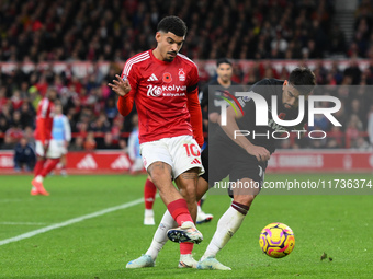 Morgan Gibbs-White of Nottingham Forest battles with Lucas Paqueta of West Ham United during the Premier League match between Nottingham For...