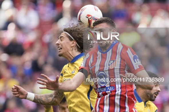 In Madrid, Spain, on November 3, Clement Lenglet of Atletico de Madrid and Fabio Silva of Las Palmas fight for the ball during the La Liga 2...