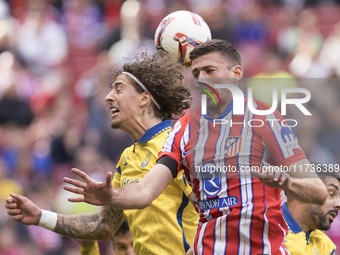 In Madrid, Spain, on November 3, Clement Lenglet of Atletico de Madrid and Fabio Silva of Las Palmas fight for the ball during the La Liga 2...