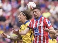 In Madrid, Spain, on November 3, Clement Lenglet of Atletico de Madrid and Fabio Silva of Las Palmas fight for the ball during the La Liga 2...