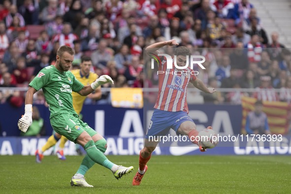 Julian Alvarez of Atletico de Madrid and Jasper Cillessen of Las Palmas are in action during the La Liga 2024/25 match between Atletico de M...