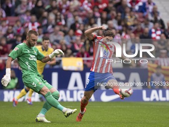 Julian Alvarez of Atletico de Madrid and Jasper Cillessen of Las Palmas are in action during the La Liga 2024/25 match between Atletico de M...