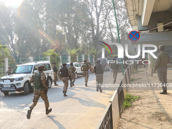 Indian paramilitary troops run towards the site of a grenade explosion in Srinagar, Indian-administered Kashmir, on November 3, 2024. Ten pe...