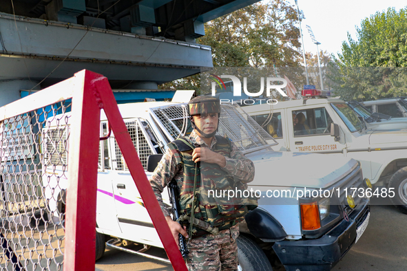 An Indian paramilitary trooper remains on alert near the site of a grenade explosion in Srinagar, Indian-administered Kashmir, on November 3...