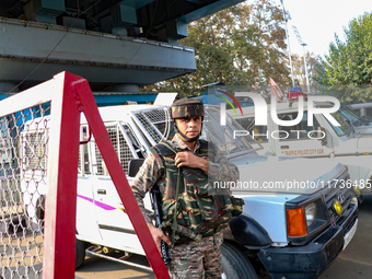 An Indian paramilitary trooper remains on alert near the site of a grenade explosion in Srinagar, Indian-administered Kashmir, on November 3...