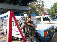 An Indian paramilitary trooper remains on alert near the site of a grenade explosion in Srinagar, Indian-administered Kashmir, on November 3...