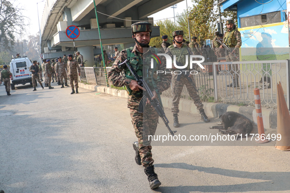 Indian paramilitary troops run towards the site of a grenade explosion in Srinagar, Indian-administered Kashmir, on November 3, 2024. Ten pe...