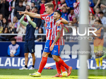 Alexander Sorloth of Atletico de Madrid (L) celebrates his goal with Angel Correa of Atletico de Madrid (R) during the La Liga EA Sports 202...