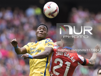 Javi Galan of Atletico de Madrid and Dario Essugo of Las Palmas fight for the ball during the La Liga 2024/25 match between Atletico de Madr...