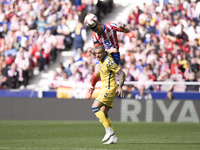 Javi Galan of Atletico de Madrid and Sandro Ramirez of Las Palmas fight for the ball during the La Liga 2024/25 match between Atletico de Ma...