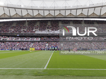 In Madrid, Spain, on November 3, players from Atletico de Madrid and Las Palmas show respect for the victims of the Valencia rains during th...