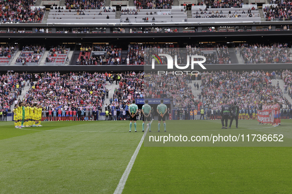 In Madrid, Spain, on November 3, players from Atletico de Madrid and Las Palmas show respect for the victims of the Valencia rains during th...