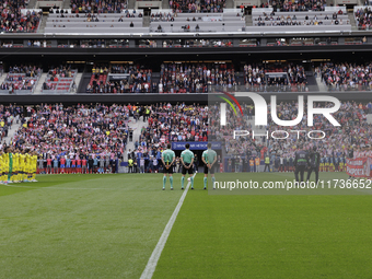 In Madrid, Spain, on November 3, players from Atletico de Madrid and Las Palmas show respect for the victims of the Valencia rains during th...