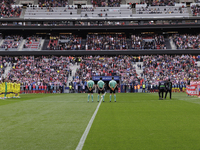 In Madrid, Spain, on November 3, players from Atletico de Madrid and Las Palmas show respect for the victims of the Valencia rains during th...