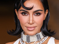 Kim Kardashian wearing a custom Gucci dress and coat with a Tallarico pearl choker, Bvlgari pearl and diamond necklace, and Princess Diana's...