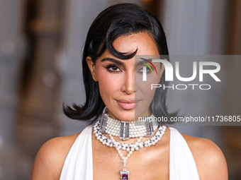 Kim Kardashian wearing a custom Gucci dress and coat with a Tallarico pearl choker, Bvlgari pearl and diamond necklace, and Princess Diana's...