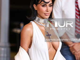 Kim Kardashian wearing a custom Gucci dress and coat with a Tallarico pearl choker, Bvlgari pearl and diamond necklace, and Princess Diana's...