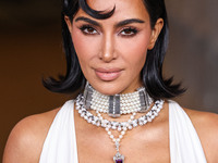 Kim Kardashian wearing a custom Gucci dress and coat with a Tallarico pearl choker, Bvlgari pearl and diamond necklace, and Princess Diana's...