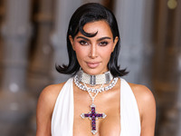 Kim Kardashian wearing a custom Gucci dress and coat with a Tallarico pearl choker, Bvlgari pearl and diamond necklace, and Princess Diana's...