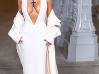 Kim Kardashian wearing a custom Gucci dress and coat with a Tallarico pearl choker, Bvlgari pearl and diamond necklace, and Princess Diana's...