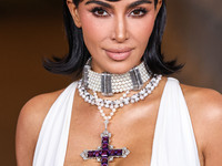 Kim Kardashian wearing a custom Gucci dress and coat with a Tallarico pearl choker, Bvlgari pearl and diamond necklace, and Princess Diana's...