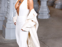 Kim Kardashian wearing a custom Gucci dress and coat with a Tallarico pearl choker, Bvlgari pearl and diamond necklace, and Princess Diana's...