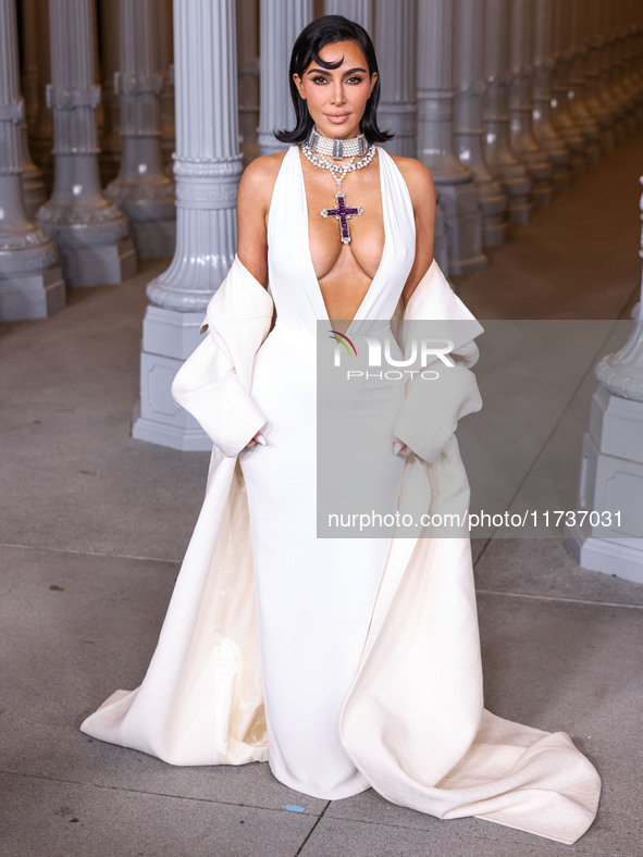 Kim Kardashian wearing a custom Gucci dress and coat with a Tallarico pearl choker, Bvlgari pearl and diamond necklace, and Princess Diana's...