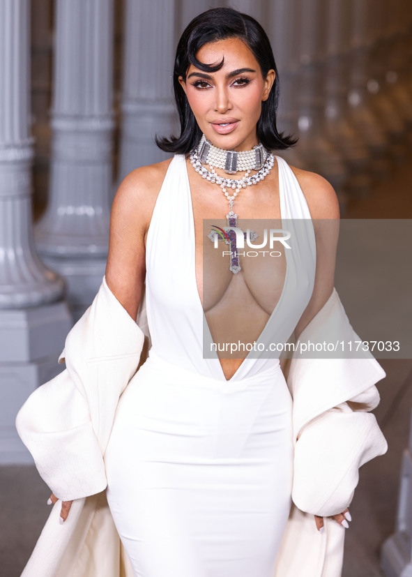 Kim Kardashian wearing a custom Gucci dress and coat with a Tallarico pearl choker, Bvlgari pearl and diamond necklace, and Princess Diana's...