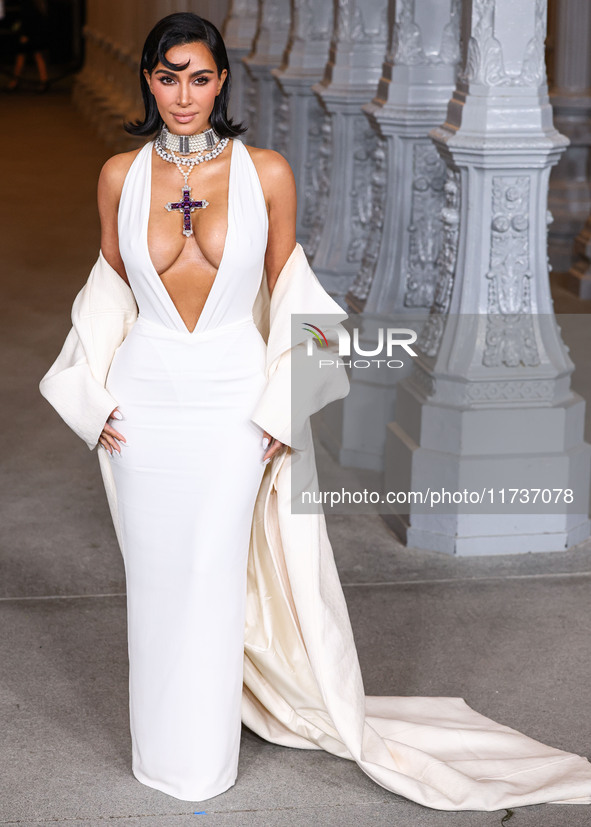 Kim Kardashian wearing a custom Gucci dress and coat with a Tallarico pearl choker, Bvlgari pearl and diamond necklace, and Princess Diana's...