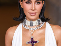 Kim Kardashian wearing a custom Gucci dress and coat with a Tallarico pearl choker, Bvlgari pearl and diamond necklace, and Princess Diana's...